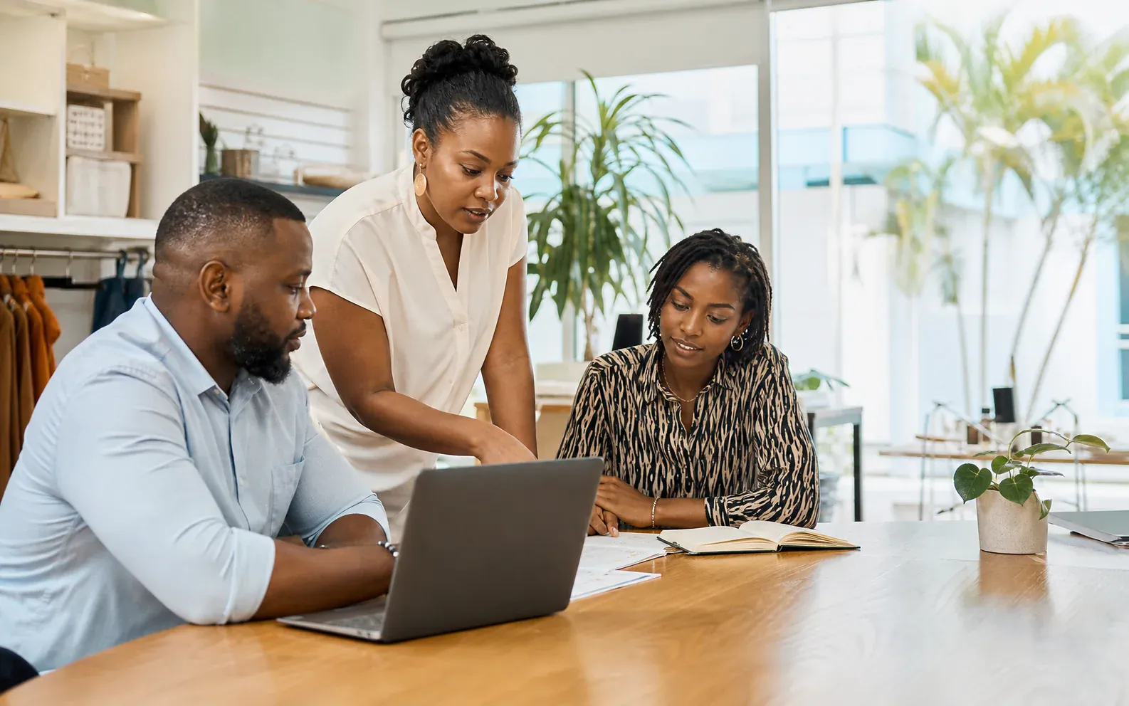 A Caribbean employer reviewing a role with members of their team