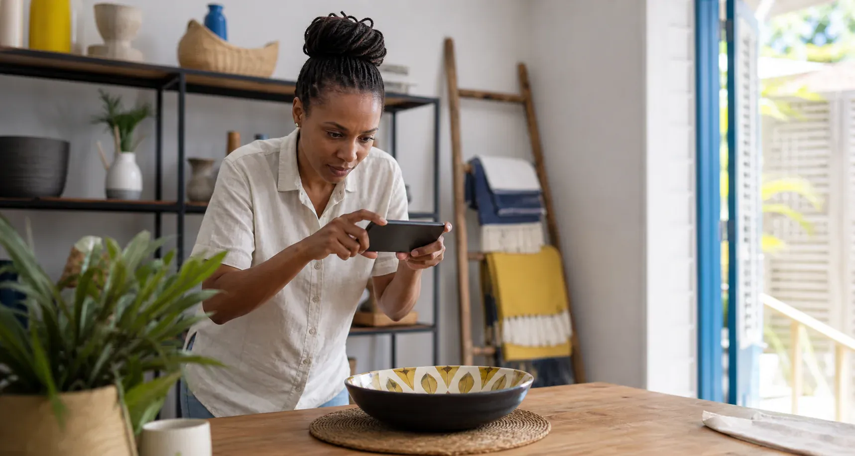 A Caribbean seller photographing a household item for an online listing